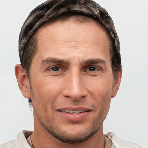 Joyful white adult male with short  brown hair and brown eyes