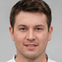 Joyful white young-adult male with short  brown hair and brown eyes