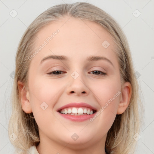 Joyful white young-adult female with medium  brown hair and blue eyes