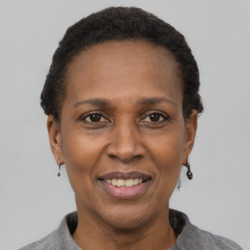 Joyful latino adult female with short  black hair and brown eyes