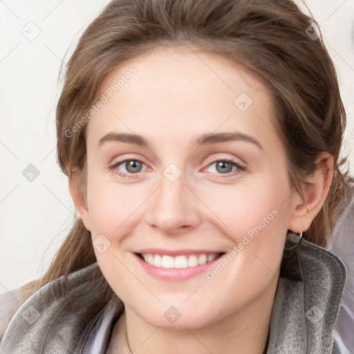 Joyful white young-adult female with long  brown hair and blue eyes