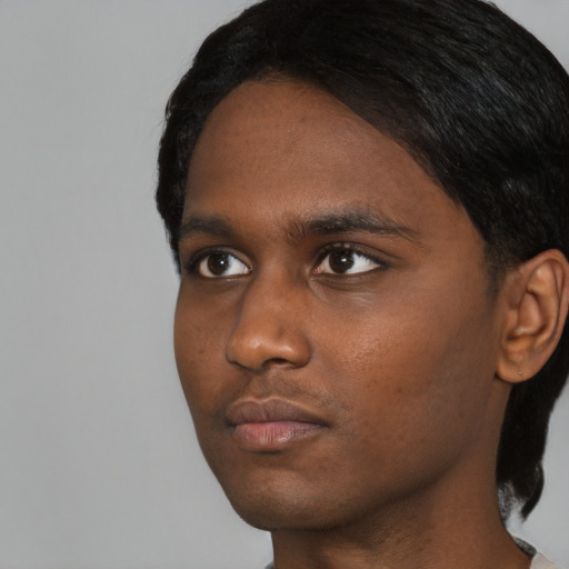 Neutral black young-adult male with short  black hair and brown eyes
