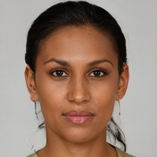 Joyful black young-adult female with medium  brown hair and brown eyes