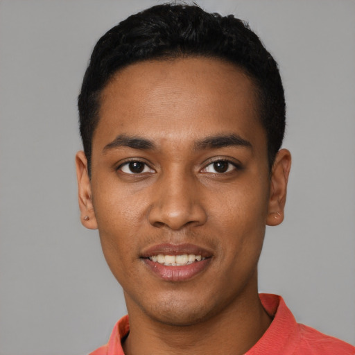 Joyful black young-adult male with short  black hair and brown eyes
