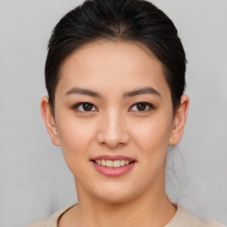 Joyful asian young-adult female with short  brown hair and brown eyes