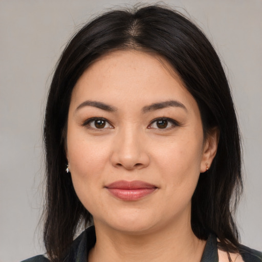 Joyful asian young-adult female with medium  brown hair and brown eyes