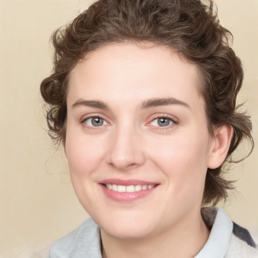 Joyful white young-adult female with medium  brown hair and green eyes