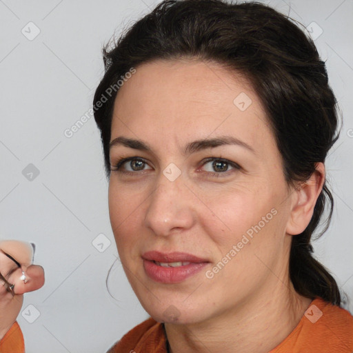 Joyful white adult female with medium  brown hair and brown eyes