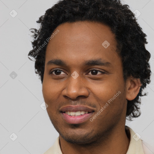 Joyful black young-adult male with short  brown hair and brown eyes