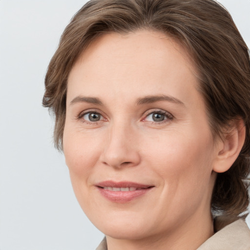 Joyful white adult female with medium  brown hair and grey eyes