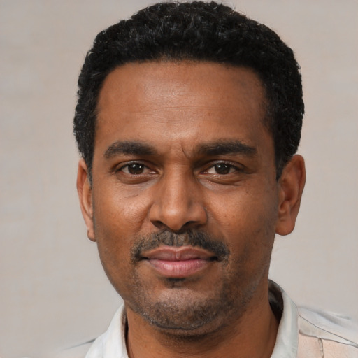 Neutral latino adult male with short  black hair and brown eyes