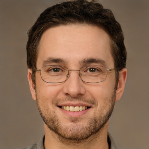 Joyful white adult male with short  brown hair and brown eyes