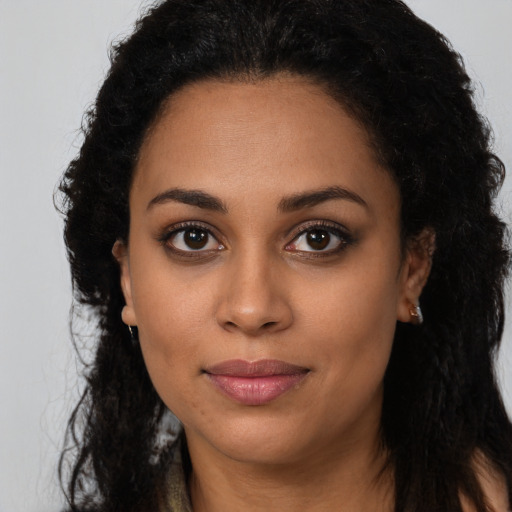 Joyful latino young-adult female with long  brown hair and brown eyes