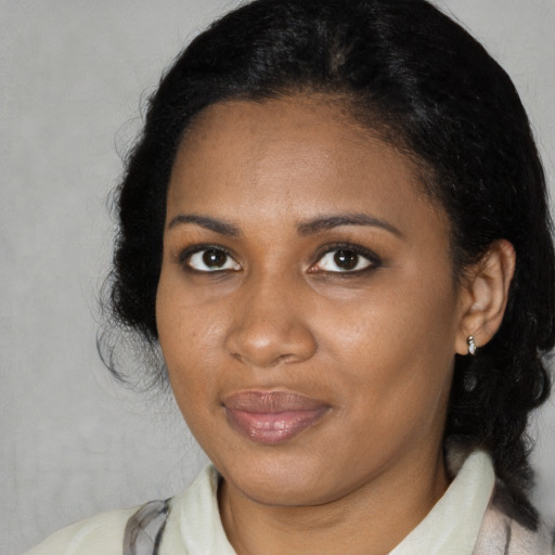 Joyful black adult female with medium  black hair and brown eyes