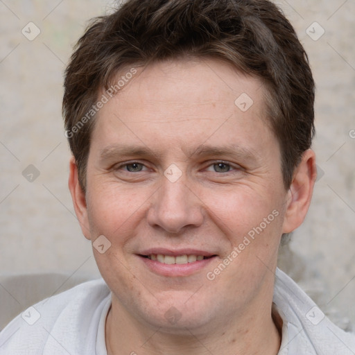 Joyful white adult male with short  brown hair and grey eyes