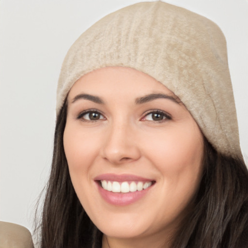 Joyful white young-adult female with long  black hair and brown eyes