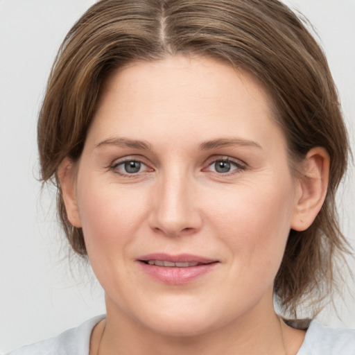 Joyful white young-adult female with medium  brown hair and brown eyes