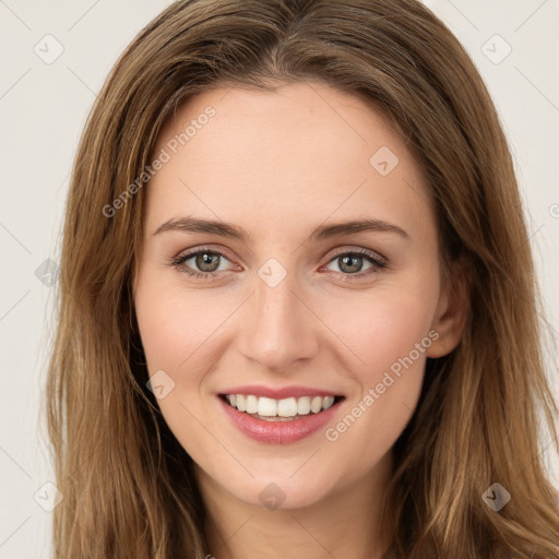 Joyful white young-adult female with long  brown hair and green eyes