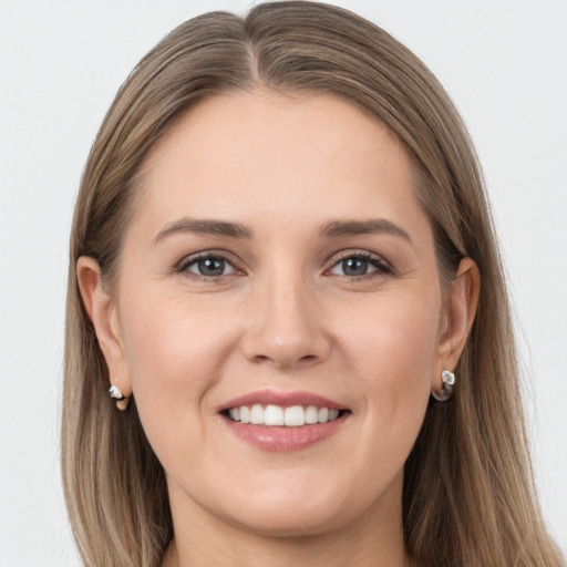 Joyful white young-adult female with long  brown hair and grey eyes