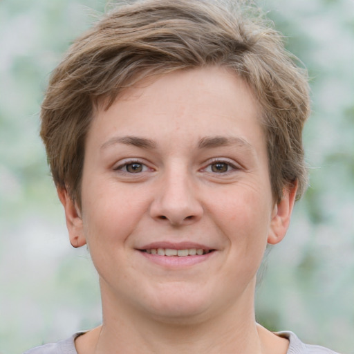 Joyful white young-adult female with short  brown hair and grey eyes