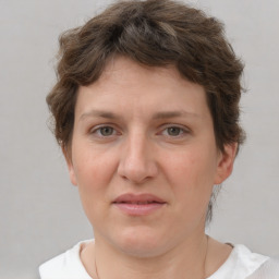 Joyful white adult female with short  brown hair and grey eyes