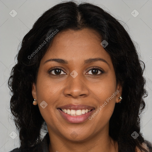 Joyful black young-adult female with long  brown hair and brown eyes