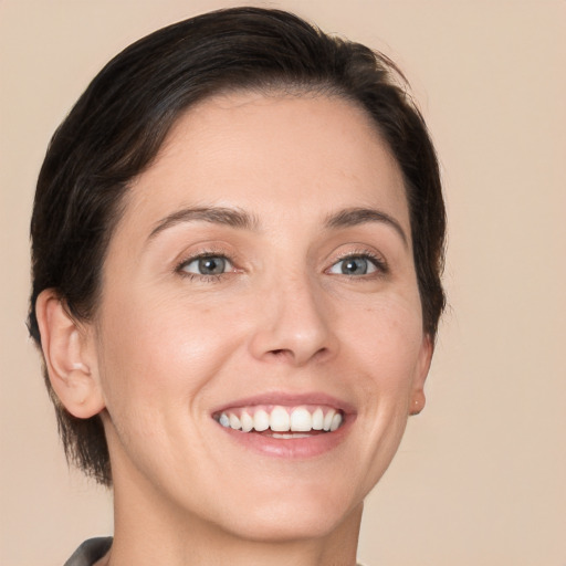 Joyful white young-adult female with medium  brown hair and brown eyes