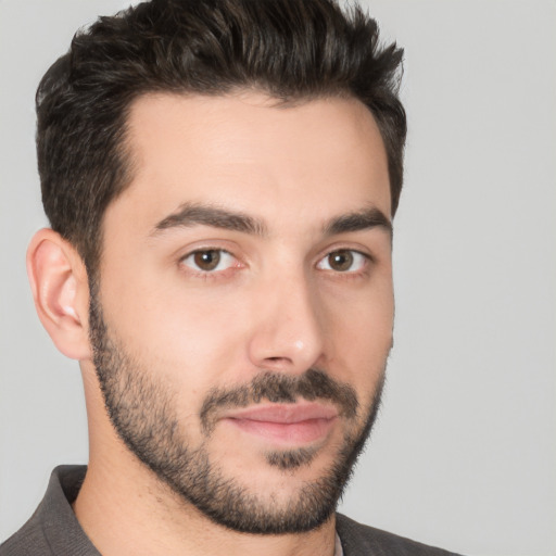 Joyful white young-adult male with short  black hair and brown eyes