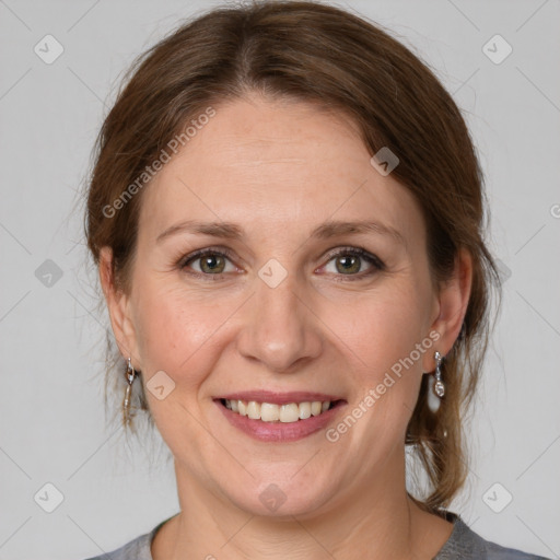 Joyful white adult female with medium  brown hair and grey eyes