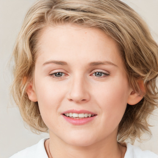 Joyful white young-adult female with medium  brown hair and blue eyes