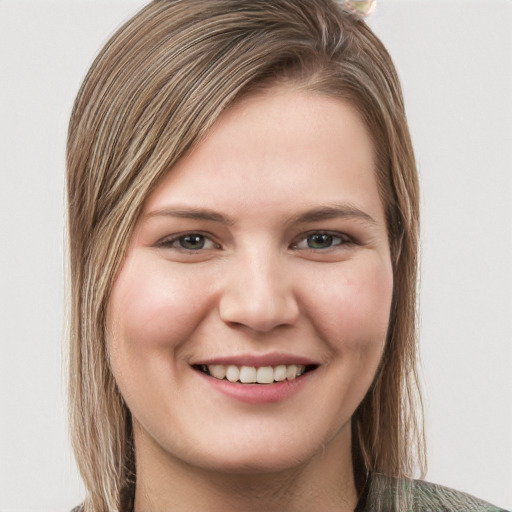 Joyful white young-adult female with long  brown hair and green eyes