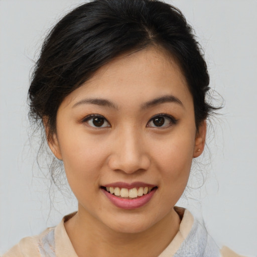 Joyful asian young-adult female with medium  brown hair and brown eyes