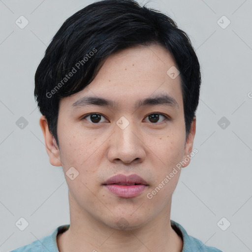 Joyful asian young-adult male with short  black hair and brown eyes