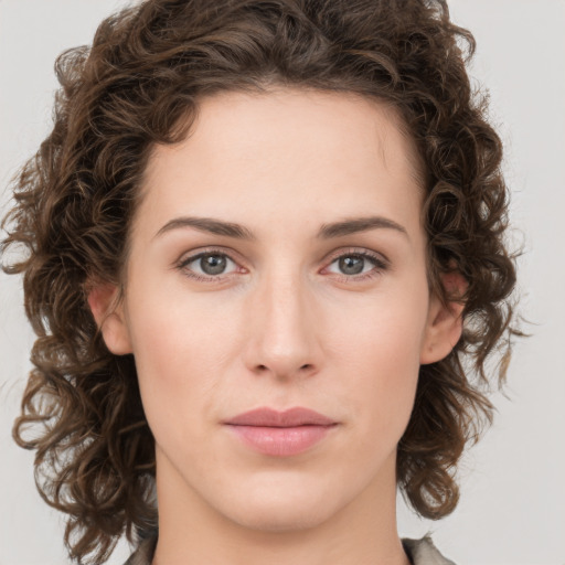 Joyful white young-adult female with medium  brown hair and green eyes