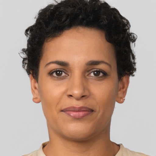 Joyful latino young-adult female with short  brown hair and brown eyes