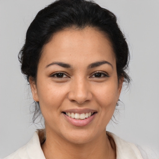 Joyful latino young-adult female with medium  brown hair and brown eyes