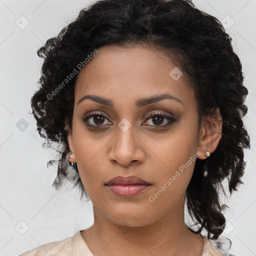 Joyful black young-adult female with long  brown hair and brown eyes