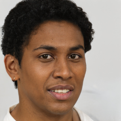 Joyful black young-adult male with short  brown hair and brown eyes