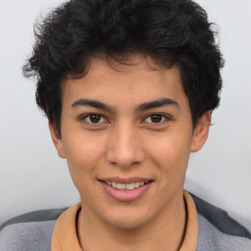 Joyful latino young-adult male with short  brown hair and brown eyes