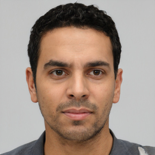 Neutral latino young-adult male with short  black hair and brown eyes