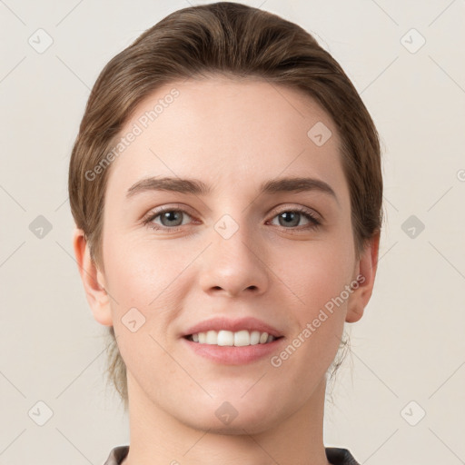 Joyful white young-adult female with short  brown hair and grey eyes