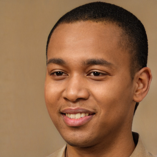 Joyful black young-adult male with short  brown hair and brown eyes