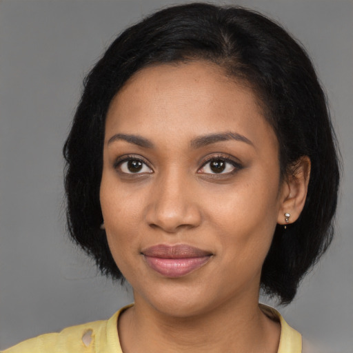 Joyful black young-adult female with medium  brown hair and brown eyes