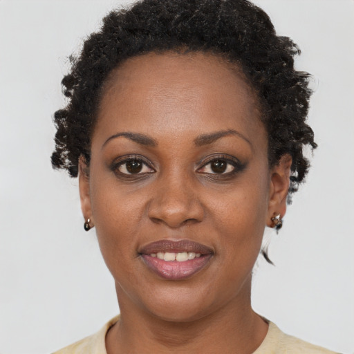 Joyful black adult female with short  brown hair and brown eyes