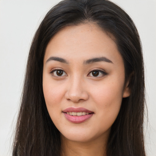 Joyful asian young-adult female with long  brown hair and brown eyes