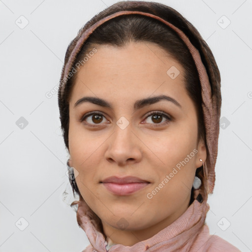 Joyful latino young-adult female with short  brown hair and brown eyes