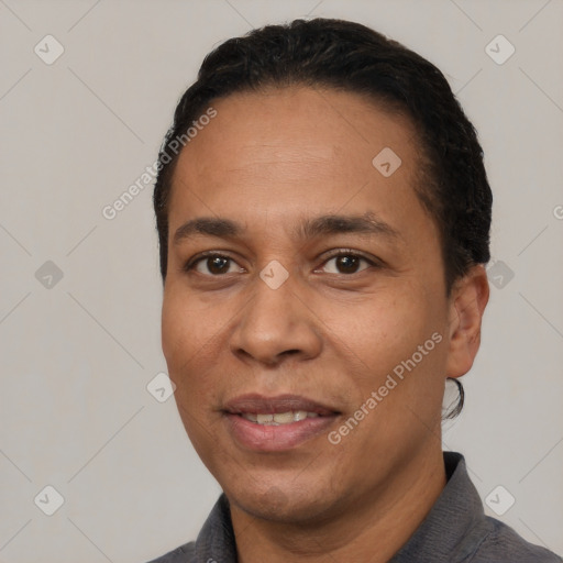 Joyful white adult male with short  black hair and brown eyes