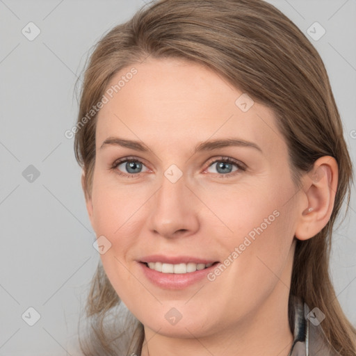 Joyful white young-adult female with long  brown hair and grey eyes