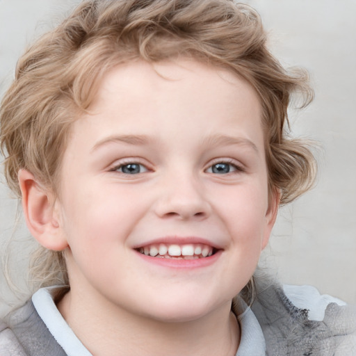 Joyful white child female with short  brown hair and blue eyes