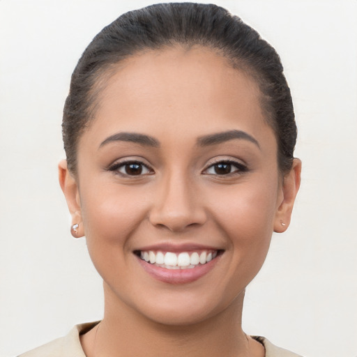 Joyful latino young-adult female with short  brown hair and brown eyes